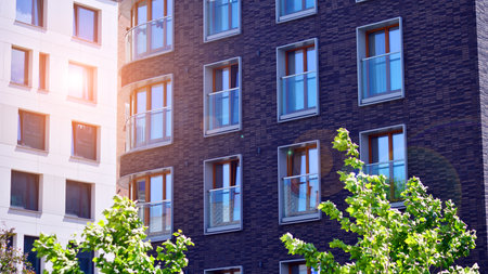 New modern block of flats in green area. complex. New modern block of flats in green area. European residential architecture harmonizing with nature. Eco-friendly living in city wiの写真素材