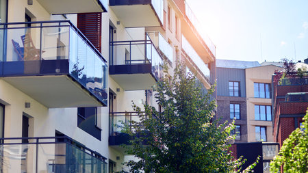 New modern block of flats in green area. complex. New modern block of flats in green area. European residential architecture harmonizing with nature. Eco-friendly living in city wiの写真素材