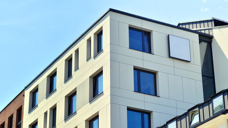 Modern apartment buildings on a sunny day with a blue sky. Facade of a modern apartment building....