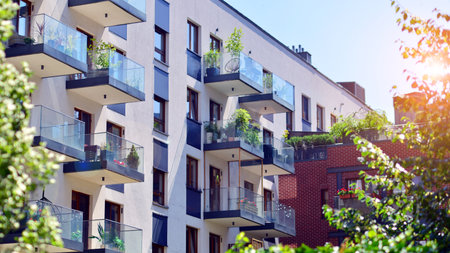 New modern block of flats in green area. complex. New modern block of flats in green area. European residential architecture harmonizing with nature. Eco-friendly living in city wiの写真素材