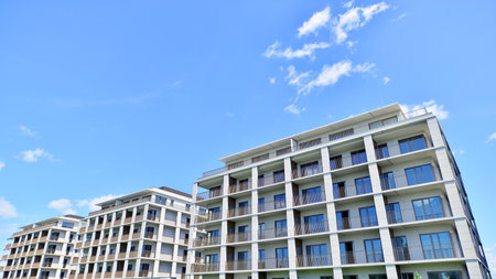 Modern apartment buildings on a sunny day with a blue sky. Facade of a modern apartment building....