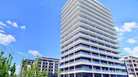 Exterior of a high modern multi-story apartment building - facade, windows and balconies.の写真素材