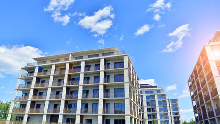 Modern apartment buildings on a sunny day with a blue sky. Facade of a modern apartment building. Modern residential apartment building complex condo.の写真素材