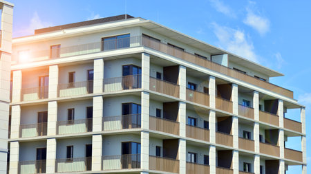 Modern apartment buildings on a sunny day with a blue sky. Facade of a modern apartment building. Modern residential apartment building complex condo.の写真素材