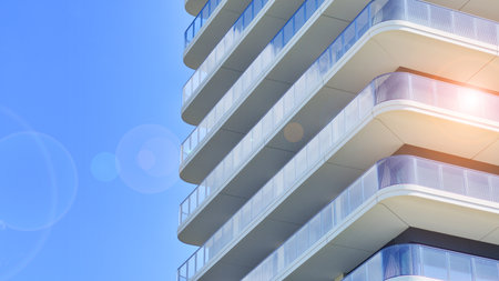 Exterior of a high modern multi-story apartment building - facade, windows and balconies.の写真素材