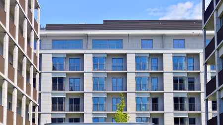 Modern apartment buildings on a sunny day with a blue sky. Facade of a modern apartment building. Modern residential apartment building complex condo.の写真素材