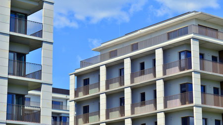 Modern apartment buildings on a sunny day with a blue sky. Facade of a modern apartment building. Modern residential apartment building complex condo.の写真素材