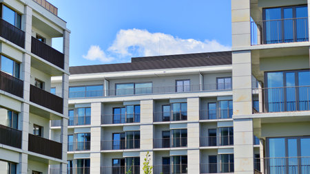 Modern apartment buildings on a sunny day with a blue sky. Facade of a modern apartment building. Modern residential apartment building complex condo.の写真素材