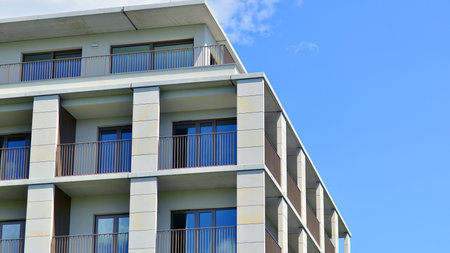Modern apartment buildings on a sunny day with a blue sky. Facade of a modern apartment building. Modern residential apartment building complex condo.の写真素材