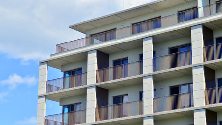 Modern apartment buildings on a sunny day with a blue sky. Facade of a modern apartment building. Modern residential apartment building complex condo.の写真素材