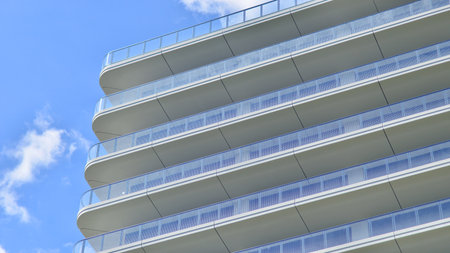 Exterior of a high modern multi-story apartment building - facade, windows and balconies.の写真素材