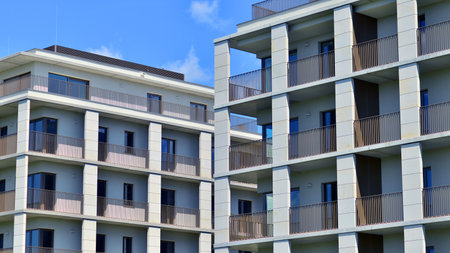 Modern apartment buildings on a sunny day with a blue sky. Facade of a modern apartment building. Modern residential apartment building complex condo.の写真素材