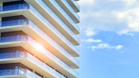 Exterior of a high modern multi-story apartment building - facade, windows and balconies.の写真素材