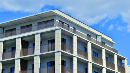 Modern apartment buildings on a sunny day with a blue sky. Facade of a modern apartment building. Modern residential apartment building complex condo.の写真素材