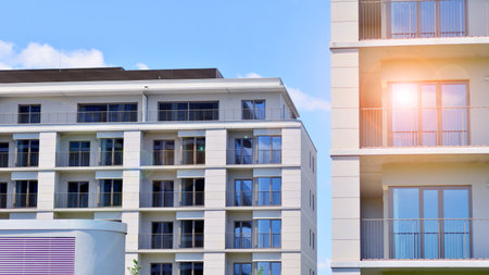 Modern apartment buildings on a sunny day with a blue sky. Facade of a modern apartment building. Modern residential apartment building complex condo.の写真素材