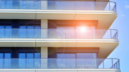 Modern apartment buildings on a sunny day with a blue sky. Facade of a modern apartment building. Modern residential apartment building complex condo.の写真素材