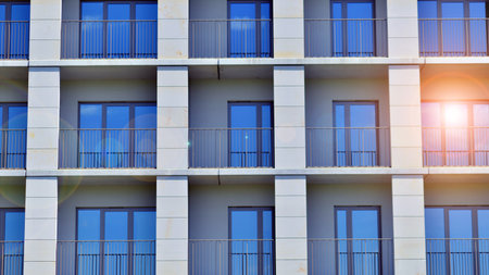 Modern apartment buildings on a sunny day with a blue sky. Facade of a modern apartment building. Modern residential apartment building complex condo.の写真素材