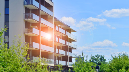 European residential architecture harmonizing with nature. Eco-friendly living in city with greens. Eco apartment building saving energy and fresh air concept.の写真素材