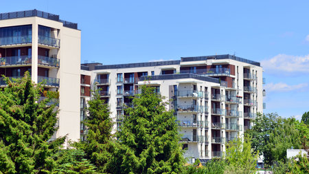 European residential architecture harmonizing with nature. Eco-friendly living in city with greens. Eco apartment building saving energy and fresh air concept.の写真素材