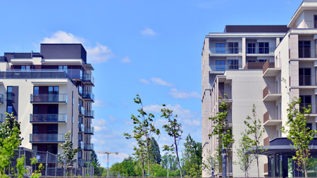 European residential architecture harmonizing with nature. Eco-friendly living in city with greens. Eco apartment building saving energy and fresh air concept.の写真素材