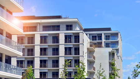 European residential architecture harmonizing with nature. Eco-friendly living in city with greens. Eco apartment building saving energy and fresh air concept.の写真素材