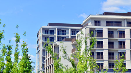 European residential architecture harmonizing with nature. Eco-friendly living in city with greens. Eco apartment building saving energy and fresh air concept.の写真素材