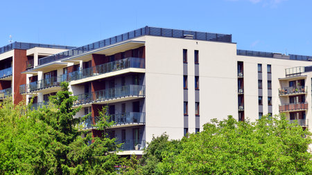 European residential architecture harmonizing with nature. Eco-friendly living in city with greens. Eco apartment building saving energy and fresh air concept.の写真素材