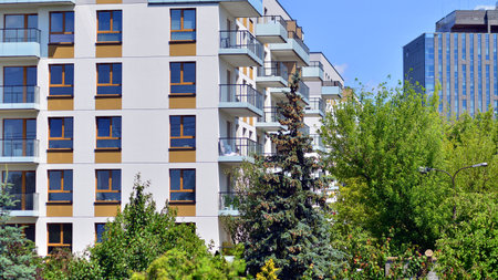 European residential architecture harmonizing with nature. Eco-friendly living in city with greens. Eco apartment building saving energy and fresh air concept.の写真素材