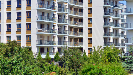European residential architecture harmonizing with nature. Eco-friendly living in city with greens. Eco apartment building saving energy and fresh air concept.の写真素材