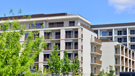 European residential architecture harmonizing with nature. Eco-friendly living in city with greens. Eco apartment building saving energy and fresh air concept.の写真素材
