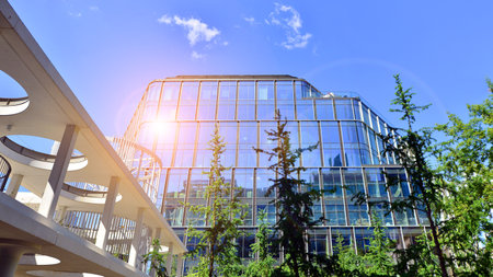 Sustainable glass office building with trees for reducing carbon dioxide. Eco-friendly building in modern city. Office with green environment. Corporate building reduce CO2.の写真素材