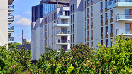 European residential architecture harmonizing with nature. Eco-friendly living in city with greens. Eco apartment building saving energy and fresh air concept.の写真素材