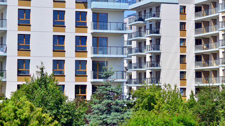 European residential architecture harmonizing with nature. Eco-friendly living in city with greens. Eco apartment building saving energy and fresh air concept.の写真素材