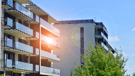 European residential architecture harmonizing with nature. Eco-friendly living in city with greens. Eco apartment building saving energy and fresh air concept.の写真素材