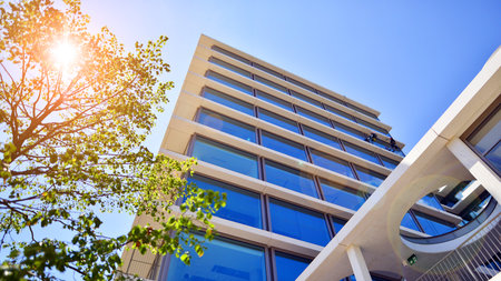 Office with green environment. Corporate building reduce CO2. Sustainable glass office building with trees for reducing carbon dioxide. Eco-friendly building in modern city.の写真素材