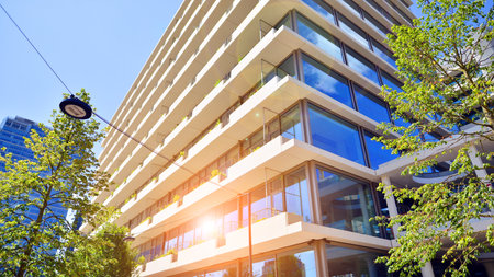 Office with green environment. Corporate building reduce CO2. Sustainable glass office building with trees for reducing carbon dioxide. Eco-friendly building in modern city.の写真素材