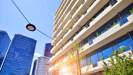 Office with green environment. Corporate building reduce CO2. Sustainable glass office building with trees for reducing carbon dioxide. Eco-friendly building in modern city.の写真素材