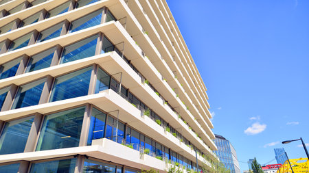Office with green environment. Corporate building reduce CO2. Sustainable glass office building with trees for reducing carbon dioxide. Eco-friendly building in modern city.の写真素材