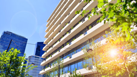 Office with green environment. Corporate building reduce CO2. Sustainable glass office building with trees for reducing carbon dioxide. Eco-friendly building in modern city.の写真素材