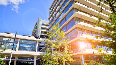 Office with green environment. Corporate building reduce CO2. Sustainable glass office building with trees for reducing carbon dioxide. Eco-friendly building in modern city.の写真素材