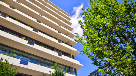 Office with green environment. Corporate building reduce CO2. Sustainable glass office building with trees for reducing carbon dioxide. Eco-friendly building in modern city.の写真素材