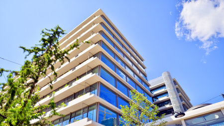 Office with green environment. Corporate building reduce CO2. Sustainable glass office building with trees for reducing carbon dioxide. Eco-friendly building in modern city.の写真素材