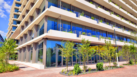 Office with green environment. Corporate building reduce CO2. Sustainable glass office building with trees for reducing carbon dioxide. Eco-friendly building in modern city.の写真素材