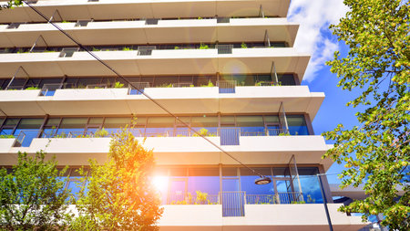 Office with green environment. Corporate building reduce CO2. Sustainable glass office building with trees for reducing carbon dioxide. Eco-friendly building in modern city.の写真素材