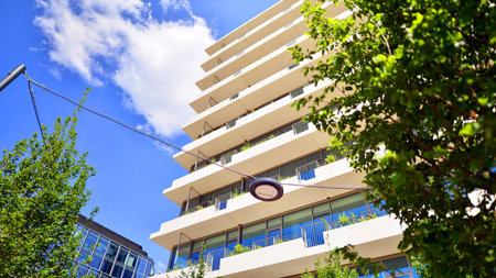 Office with green environment. Corporate building reduce CO2. Sustainable glass office building with trees for reducing carbon dioxide. Eco-friendly building in modern city.の写真素材