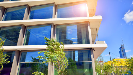 Office with green environment. Corporate building reduce CO2. Sustainable glass office building with...