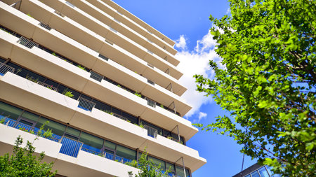 Office with green environment. Corporate building reduce CO2. Sustainable glass office building with trees for reducing carbon dioxide. Eco-friendly building in modern city.の写真素材