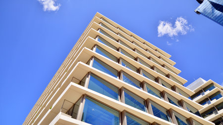 Modern office building with glass facade. Transparent glass wall of office building. Reflection of...