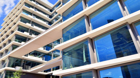 Downtown corporate business district architecture. Glass reflective office buildings against blue sky and sun light. Economy, finance, business activity concept. Abstract modern aの写真素材