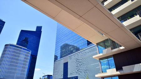 Downtown corporate business district architecture. Glass reflective office buildings against blue sky and sun light. Economy, finance, business activity concept. Abstract modern aの写真素材